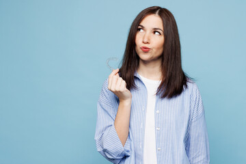 Young smiling minded woman wear shirt casual clothes hold in hand invisible transparent aligners,...