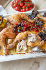 Roasted chicken legs with oven vegetables on a baking tray fresh and homemade cooked