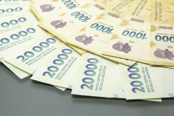 Argentine Money, Currency of Argentine, Pesos argentinos, various bills on dark background. Cash money