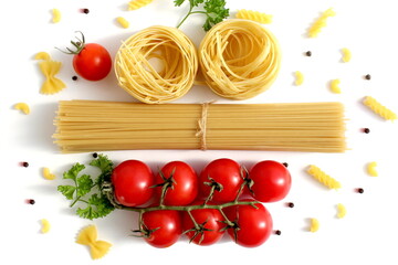 Fresh ripe harvest of vegetables lies on white isolated background with dry pasta before cooking.