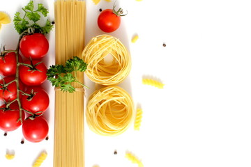Fresh ripe harvest of vegetables lies on white isolated background with dry pasta before cooking.