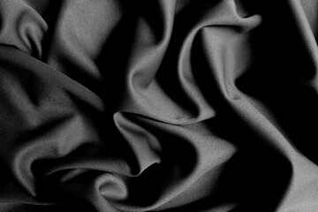 The fabric lies beautifully draped with folds of a bright, rich color.	