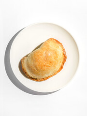 traditional Latin American empanadas on a white plate