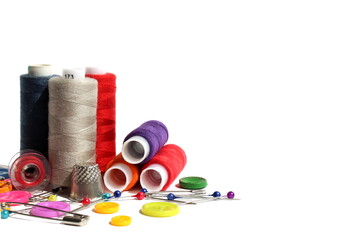 Sewing supplies lie on a white isolated background.