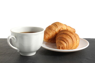 A cup of coffee with a croissant is on the table.
