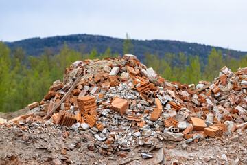 Construction waste dump with a pile of broken bricks and a pile of masonry.