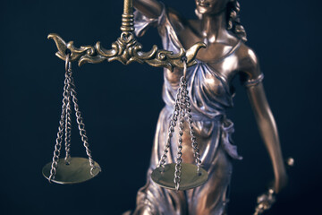 Statue of Themis Lady of Justice symbol on black background