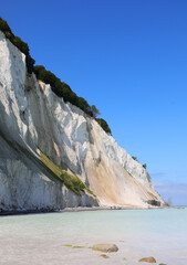 white chalk cliff of calcium carbonate by the Baltic Sea in southern Denmark in Europe and the sky