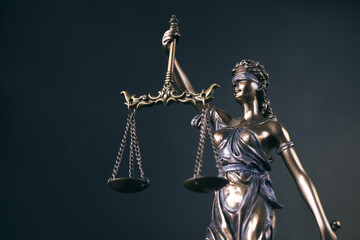 Statue of Themis Lady of Justice symbol on black background