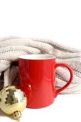 On a white background there is a red mug with cocoa, Christmas theme.