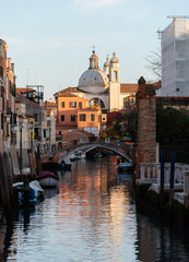 Naklejka premium Quiet Venetian Canal with Church of San Pietro in the Distance