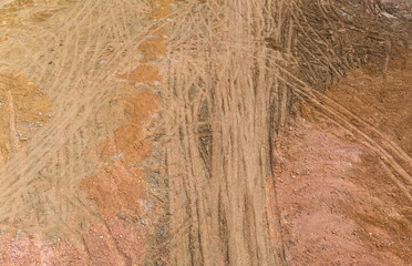 Wheel tracks on the ground on the dirt road.