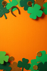 St. Patrick's Day vertical background with green and gold shamrocks, gold coins, and a horseshoe on...