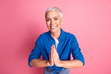 Photo of charming positive woman wear blue shirt arms together begging you empty space isolated...
