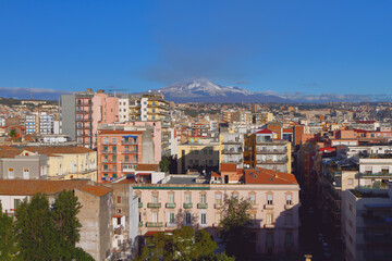 City and Mount Etna volcano in december. Catania, Sicily, Italy