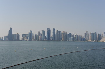 Panoramic view of modern skyscrapers of Doha capital city cityscape on a sunny day in summer, Doha, Qatar