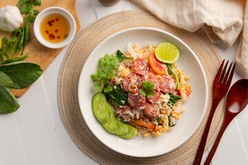 Thai Fried Rice with Sour Pork, Stir fried rice with fermented pork and egg in white plate.(Khao Pad Naem).Top view.