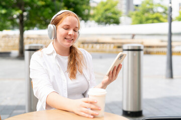 Enjoying a relaxing moment with coffee and music in an urban cafe environment