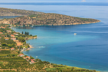 Fototapeta premium Scenic coastal view with blue waters and lush greenery, Greece, Peloponnese