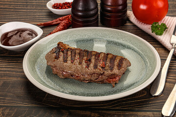 Grilled beef striploin steak with sauce