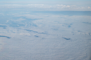 View of clouds from airplane window, background with clouds.