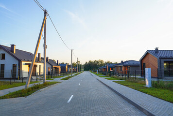 Street road in gated community. Suburban Scandi home in rural. Modern Scandinavian houses in Village. House in suburban neighborhood. Family Home in countryside. Home in countryside. Farmhouse.