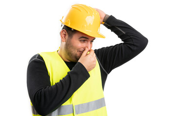 Builder smelling armpit after work making grossed gesture