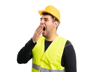Constructor covering mouth while yawning as tired concept