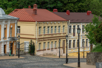 Early spring or summer morning at empty Andriyivsky Descent. One of the oldest streets in Kyiv, Ukraine, with the classic two-story brick houses and cobblestones on the road.