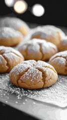 Delicious powdered sugar cookies arranged on a tray, showcasing their golden-brown color, with a blurred background creating a cozy atmosphere.
