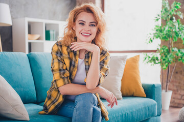 Photo of lovely young blonde girl sit couch minded dreamy dressed yellow plaid garment spacious house indoors room