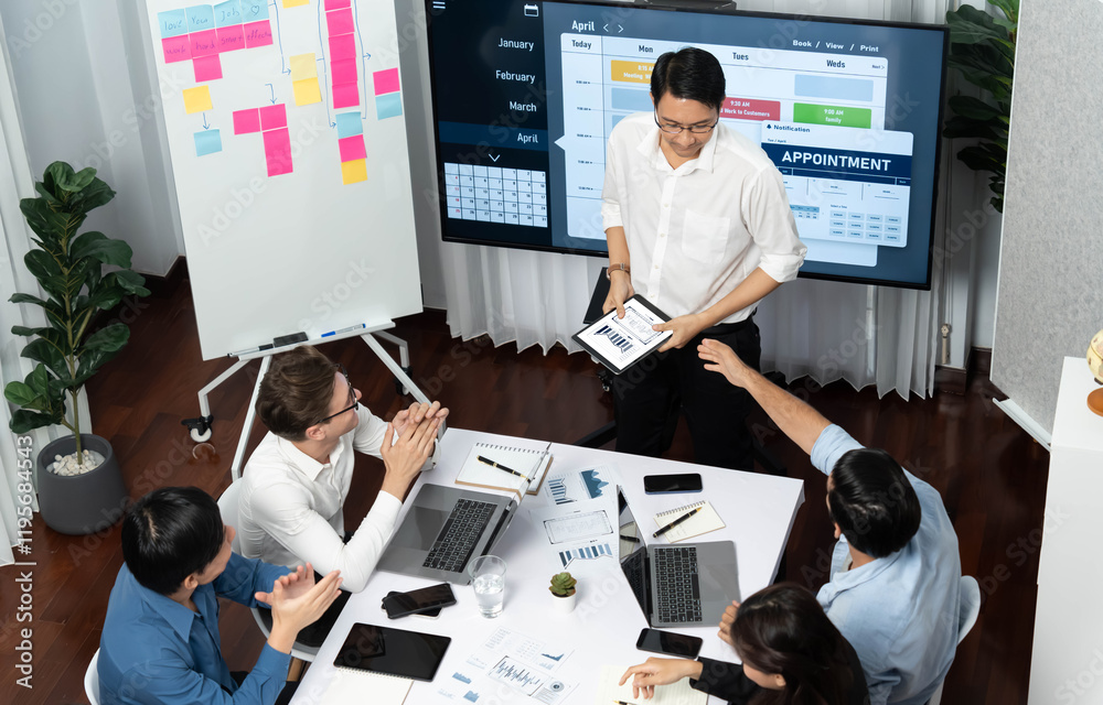 Leinwandbilder Project manager communicate and collaborate with team using project management software display on monitor, tracking progress of project task and making schedule plan at meeting table. Prudent
