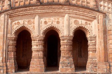 Fototapeta premium religious carvings on wall of Garh Panchakot Pancharatna temple, also known as Ras Mandir, 16th century Hindu terracotta temple built by Singh Deo dynasty of Panchkot. Now a popular travel destination