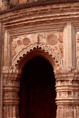 Obraz premium religious carvings on wall of Garh Panchakot Pancharatna temple, also known as Ras Mandir, 16th century Hindu terracotta temple built by Singh Deo dynasty of Panchkot. Now a popular travel destination