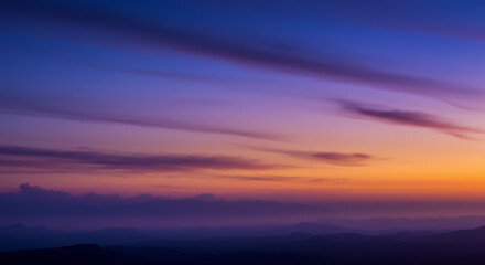 Fototapeta premium Serene Sunset over Misty Mountains: Breathtaking Landscape Photography