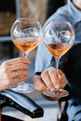 Toasting with rose wine in elegant glasses, capturing a moment of celebration and joy