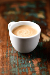 Cup of coffee on wooden background. Soft focus.