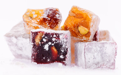 Sweet food Turkish delight, assorted rahat locum in form of cubes with nuts and powdered sugar, traditional food, on white background