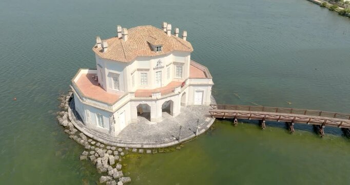 Aerial view of the Casina Vanvitelliana located on a small island in Lake Fusaro in Bacoli, in the metropolitan city of Naples, in Campania, Italy. It is an old hunting lodge in baroque style.