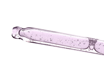 Cosmetic serum or medicine in a pipette. Closeup, white background.