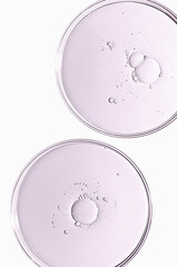 The texture of a cosmetic serum or body gel in a Petri dish.