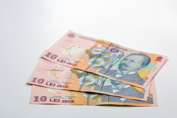 Ten leu banknotes of Romania money closeup on white.