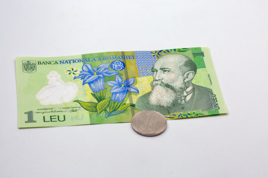 One leu banknote and ten bani coin Romania money closeup.