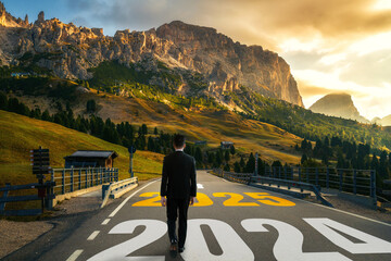 Fototapeta premium 2025 New Year journey and future vision concept . Businessman traveling on highway road leading forward to happy new year celebration in beginning of 2025 for elation and successful start .