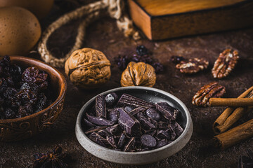 Chocolate and other baking ingredients on vintage table, brown colors
