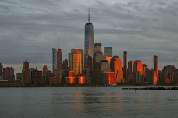 Fototapeta premium Manhattan skyline with WTC. Financial District NYC. Twin Towers memorial. World Trade Center over Hudson river.