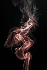 Fototapeta premium Colorful smoke swirls gracefully against a dark background during a quiet moment
