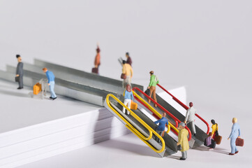 travelers walk on an escalator and a conveyor belt,