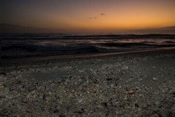 Sunset on the sea shell filled beach of Sanibel Island.