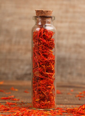jar of red safflower on wooden table